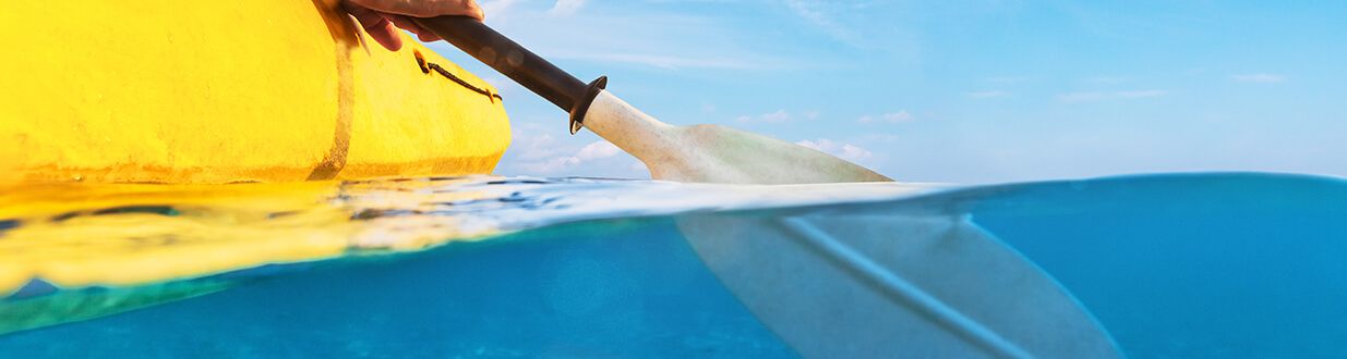 a kayak paddle in the water next to a kayak